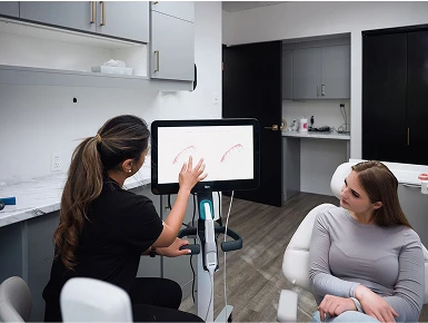 Dr. Zeidan showing a screen to a patient